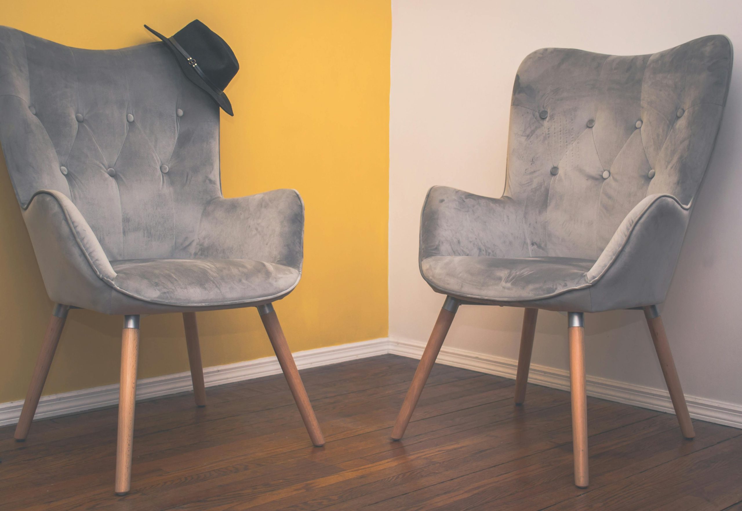 Two chairs facing each other in a calm counselling room used for couples therapy.